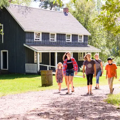 six people walking through outdoor trail at Muskoka Museum