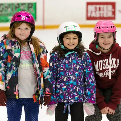 three youths taking photo together while ice skating